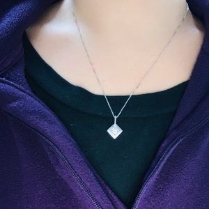 Round diamond necklace with square setting.